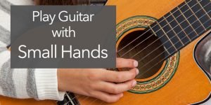 small hands on classical guitar